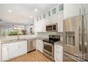 Modern kitchen boasts stainless steel appliances, granite countertops, and ample white cabinetry at 15318 Coventry Court Ln, Charlotte, NC 28277