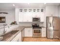 Bright kitchen featuring stainless steel appliances, granite countertops, and modern white cabinets at 15318 Coventry Court Ln, Charlotte, NC 28277
