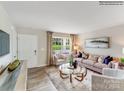 Cozy living room featuring a comfortable sofa, elegant furnishings, and a large window providing natural light at 1611 Spring Lot Dr, Edgemoor, SC 29712