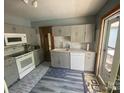 Modern kitchen features gray cabinets, marble-look countertops, and stainless steel appliances at 1658 Hillcrest Ave, Lancaster, SC 29720