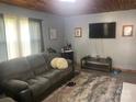 Cozy living room featuring a comfortable sofa, rug and large-screen television for entertainment at 1658 Hillcrest Ave, Lancaster, SC 29720
