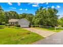 Charming home with attached garage and a long driveway framed by green landscaping at 1760 Jacobs Way, Sherrills Ford, NC 28673