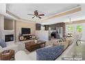 Open living room showcases a fireplace, ceiling fan, and seamless flow into the modern kitchen and dining area at 1806 Red Bird Cir, Concord, NC 28025