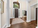 Bright foyer with hardwood floors, soaring ceilings, grand columns, and a large front door with sidelights at 18920 Peninsula Club Dr, Cornelius, NC 28031
