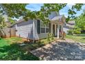 Side view of a single-Gathering home with a neatly landscaped yard and blooming flowers at 2126 Downing St, Charlotte, NC 28205