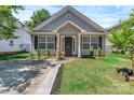 Quaint single-Gathering home featuring a lush front lawn and classic architectural details at 2126 Downing St, Charlotte, NC 28205