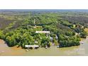 Breathtaking aerial view showcases a lake house on a wooded lot with deeded dock access at 221 Grayrock Dr, Statesville, NC 28677