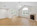 Bright living room with vaulted ceiling, fireplace, hardwood floors, and natural light at 2704 Polo Club Blvd, Matthews, NC 28105