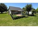 The backyard features a fenced-in garden, screened porch, and lush green lawn at 2800 Deans Ct, Monroe, NC 28110
