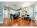 Open kitchen and dining area with an island and hardwood floors at 2988 Textile Way, Charlotte, NC 28205