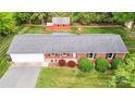 Overhead view of a brick ranch home with a large backyard and detached red outbuilding at 326 N Greenbriar Rd, Statesville, NC 28625