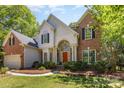 Charming brick and siding home featuring a red front door and well-maintained landscaping at 3710 Cheleys Ridge Ln, Charlotte, NC 28270