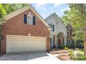 Exterior showcasing a spacious two-car garage, brick siding and manicured landscaping at 3710 Cheleys Ridge Ln, Charlotte, NC 28270