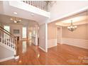 Open floor plan showcasing a large living room with a fireplace and wood flooring at 427 Pinnacle Ln, Huntersville, NC 28078