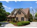 Attractive two-story home featuring brick facade, attached garage, well-maintained landscaping, and spacious driveway at 440 S Sharon Amity Rd, Charlotte, NC 28211