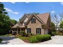 Charming brick home with attached garage and lush landscaping, offers comfort and convenience at 440 S Sharon Amity Rd, Charlotte, NC 28211