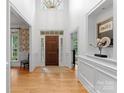 Inviting foyer with hardwood floors, high ceilings, and elegant chandelier, providing a grand entrance at 440 S Sharon Amity Rd, Charlotte, NC 28211