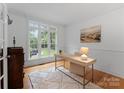 Bright home office features large windows, hardwood floors, and neutral decor, perfect for productivity at 440 S Sharon Amity Rd, Charlotte, NC 28211