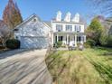 Charming two-story home with a well-manicured lawn, and a welcoming front porch at 5076 Timber Falls Dr, Indian Land, SC 29707