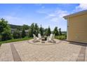 Paver patio with fire pit and Adirondack chairs, offering serene outdoor enjoyment at 6220 Raven Rock Dr, Denver, NC 28037