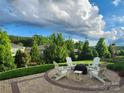 Outdoor patio with comfortable seating and lush landscaping provides the perfect setting for relaxation and entertainment at 6220 Raven Rock Dr, Denver, NC 28037