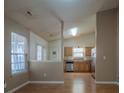 Open-concept living space featuring a combined living and dining area with kitchen access at 6808 Squirrels Foot Ct, Charlotte, NC 28217