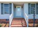 Front porch stairs with red brick, white railings, and decorative front door at 727 Skinner Rd, Shelby, NC 28152