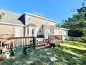 View of back exterior with spacious deck, and an easy connection to the lawn and garden at 944 Evian Ln, Matthews, NC 28015