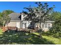 View of the back exterior with a spacious wooden deck, perfect for entertaining, surrounded by lush greenery at 944 Evian Ln, Matthews, NC 28015