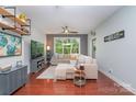 Cozy living room features a large window and a comfortable sectional sofa at 1000 E Woodlawn Rd # 315, Charlotte, NC 28209