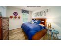 Cozy bedroom with a wooden bed frame, hardwood floors, and sports-themed decor at 1007 20Th Avenue Se Loop, Hickory, NC 28602