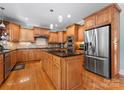 Spacious kitchen features custom wood cabinets, stainless steel appliances, and a center island at 105 Walnut Hill Ct, Mooresville, NC 28115