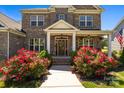 View of home with decorative entryway and colorful landscaping at 10517 Sable Cap Rd, Mint Hill, NC 28227