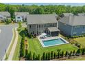 Aerial view of a home with a backyard swimming pool and well-manicured lawn at 1107 Castle Rd, Indian Land, SC 29707