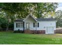 Charming single-story home featuring white siding, a brick foundation, and a well-maintained lawn at 1108 Old Dallas Hwy, Dallas, NC 28034