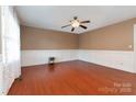 Inviting living room with beautiful wood floors, classic wainscoting, and ample natural light at 1108 Old Dallas Hwy, Dallas, NC 28034