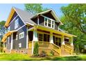 Inviting two-story home featuring a covered front porch and professionally landscaped front yard at 116 S Broad St, Waxhaw, NC 28173