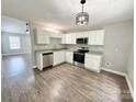 Bright kitchen features white cabinets, modern appliances, and stylish flooring at 1252 Shenandoah Cir, Rock Hill, SC 29730
