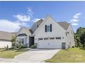 Beautiful home with a two-car garage, stone accents, and well-maintained landscaping, perfect for suburban living at 14210 Asbury Park Rd, Huntersville, NC 28078