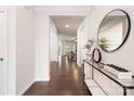 Elegant foyer with hardwood floors, modern console table, decorative mirror, and open entryway, offering a welcoming ambiance at 14210 Asbury Park Rd, Huntersville, NC 28078