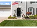 Inviting front door with manicured landscaping, and a home security system for added peace of mind at 150 Pleasant Grove Ln, Mooresville, NC 28115