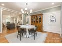 Elegant dining room with wood floors, a classic hutch, and wainscoting perfect for Gathering gatherings at 1517 Waverly Ave, Charlotte, NC 28203
