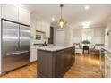 Beautiful kitchen featuring stainless steel appliances, granite countertops, an island, and hardwood flooring at 1517 Waverly Ave, Charlotte, NC 28203