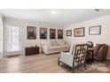 Bright living room boasts hardwood floors and stylish decor at 15746 Marvin Rd, Charlotte, NC 28277