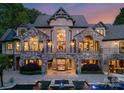 Stunning backyard featuring a stone facade, balcony, covered seating area, and luxurious pool at 172 Tennessee Cir, Mooresville, NC 28117
