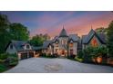 Stately home with stone and stucco facade, circular driveway, and attached garage at 172 Tennessee Cir, Mooresville, NC 28117