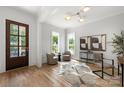 Bright foyer featuring wood floors, large windows, and comfortable seating creates a welcoming entrance to the home at 1817 Union St, Charlotte, NC 28205