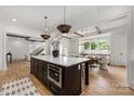 A gourmet kitchen featuring a large center island with bar seating, pendant lighting and views to the formal dining at 1817 Union St, Charlotte, NC 28205