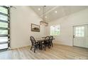 Cozy dining area with a wooden table, modern chandelier, and a window for natural light at 2003 Briarwood Cir, Fort Mill, SC 29715