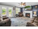 Inviting living room features a fireplace, television, ceiling fan, and comfortable seating area at 208 Wellington Dr, Lincolnton, NC 28092